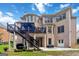 Expansive brick home featuring a covered deck and stairs leading to a spacious backyard at 2230 Cambridge Hill Ct, Dacula, GA 30019