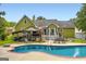 Enjoy outdoor living with a sparkling pool, shaded bar, and expansive backyard at 180 Moseley Crossing Dr, Stockbridge, GA 30281