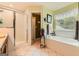 Bright bathroom with a glass door shower and separate tiled tub at 180 Moseley Crossing Dr, Stockbridge, GA 30281