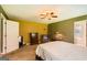 A bedroom with a ceiling fan, a dresser, and a comfortable armchair at 180 Moseley Crossing Dr, Stockbridge, GA 30281