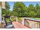 Relaxing backyard deck leading to a refreshing pool and lush green lawn at 180 Moseley Crossing Dr, Stockbridge, GA 30281