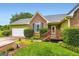 Charming entrance with wooden porch, brick accents, and well-maintained landscaping at 180 Moseley Crossing Dr, Stockbridge, GA 30281