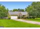 Well-manicured lawn, mature trees, and inviting facade enhance this single Gathering home at 180 Moseley Crossing Dr, Stockbridge, GA 30281