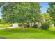 Well-maintained lawn and mature tree enhance the curb appeal of this brick home at 180 Moseley Crossing Dr, Stockbridge, GA 30281