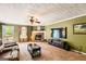 Cozy living room with brick fireplace, large TV, and comfortable seating at 180 Moseley Crossing Dr, Stockbridge, GA 30281