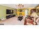 Spacious living room with carpet, a large TV, and ample seating at 180 Moseley Crossing Dr, Stockbridge, GA 30281