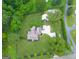 Aerial view of the property showcasing the home, expansive yard, and surrounding trees at 7093 Vaughn Rd, Canton, GA 30115