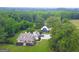 Expansive estate featuring a meticulously landscaped yard, detached building, and mature trees at 7093 Vaughn Rd, Canton, GA 30115