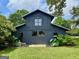 Well maintained barn featuring a dark exterior and mature foliage at 7093 Vaughn Rd, Canton, GA 30115