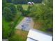 Aerial view of a private basketball and pickleball court with black chainlink fence in a verdant backyard at 7093 Vaughn Rd, Canton, GA 30115