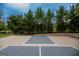 Outdoor basketball court with lines, black hoop and neutral colors, perfect for shooting hoops! at 7093 Vaughn Rd, Canton, GA 30115