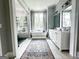 Elegant bathroom with soaking tub, glass shower, double vanities, and stylish decor at 7093 Vaughn Rd, Canton, GA 30115