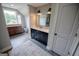 An elegant bathroom featuring dual sinks, shiplap wall design, and a bright window at 7093 Vaughn Rd, Canton, GA 30115