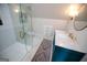 Modern bathroom with a sleek glass shower, decorative tile, and a teal vanity with gold hardware at 7093 Vaughn Rd, Canton, GA 30115