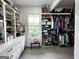 Spacious walk-in closet with custom shelving, drawers, and a window for natural light at 7093 Vaughn Rd, Canton, GA 30115
