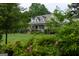 Charming home with landscaped yard, inviting porch, and well-maintained lawn at 7093 Vaughn Rd, Canton, GA 30115