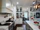 Elegant kitchen features a gas range, marble countertops, and stylish cabinetry with glass doors at 7093 Vaughn Rd, Canton, GA 30115