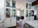 Well-designed kitchen with display cabinets, modern appliances, and a view into the dining area at 7093 Vaughn Rd, Canton, GA 30115