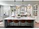 Bright and airy kitchen with a large island, pendant lighting, and stainless steel appliances at 7093 Vaughn Rd, Canton, GA 30115