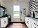 Convenient laundry room with modern appliances, countertops, cabinetry, and decorative wallpaper at 7093 Vaughn Rd, Canton, GA 30115