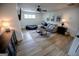 Comfortable living room area with a gray sofa, modern decor, fan, and natural light at 7093 Vaughn Rd, Canton, GA 30115