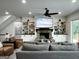 Cozy living room featuring a brick fireplace, built-in bookshelves, and comfortable seating at 7093 Vaughn Rd, Canton, GA 30115