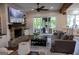 Inviting living room featuring a brick fireplace, built-in shelving, and sliding door access to a patio at 7093 Vaughn Rd, Canton, GA 30115