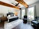 Spacious bedroom featuring exposed wood beams, hardwood floors, and large windows at 7093 Vaughn Rd, Canton, GA 30115
