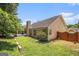 Lush backyard with well-maintained lawn, wooden fence, and mature trees, offering a private retreat at 1055 Avalon Dr, Lawrenceville, GA 30044