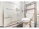 Updated bathroom with a glass enclosed shower featuring tile walls and a built-in bench at 1055 Avalon Dr, Lawrenceville, GA 30044