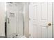 Modern bathroom with a new shower, mosaic tile, and white door at 1055 Avalon Dr, Lawrenceville, GA 30044