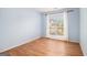 Bright bedroom featuring hardwood floors, a large window, and neutral paint, ready for personal touches at 1055 Avalon Dr, Lawrenceville, GA 30044