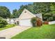 Cozy one-story home featuring a two-car garage, a driveway, and a green lawn at 1055 Avalon Dr, Lawrenceville, GA 30044