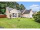 Attractive one-story home with neat landscaping, a large window, and brown shutters at 1055 Avalon Dr, Lawrenceville, GA 30044