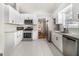 Modern kitchen with stainless steel appliances, granite countertops, and white cabinetry at 1055 Avalon Dr, Lawrenceville, GA 30044