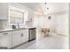 Bright kitchen features stainless appliances, granite counters, white cabinets and a dining nook at 1055 Avalon Dr, Lawrenceville, GA 30044