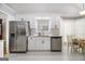 A kitchen boasts stainless steel appliances, white cabinets, granite counters and a dining nook at 1055 Avalon Dr, Lawrenceville, GA 30044