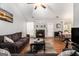 Living room features hardwood floors, fireplace, a ceiling fan, and views into the dining room at 1055 Avalon Dr, Lawrenceville, GA 30044