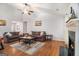 Spacious living room features hardwood floors, a fireplace, two sofas and a ceiling fan at 1055 Avalon Dr, Lawrenceville, GA 30044