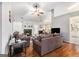 Comfortable living room with fireplace, hardwood floors and views into the dining room and kitchen at 1055 Avalon Dr, Lawrenceville, GA 30044