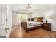Comfortable main bedroom with tray ceiling, hardwood floors, and ample natural light at 1055 Avalon Dr, Lawrenceville, GA 30044