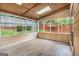 Bright sunroom with multiple windows, light-colored wood trim, and wood plank flooring at 1055 Avalon Dr, Lawrenceville, GA 30044