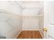 Spacious walk-in closet with ample shelving, perfect for organized storage and easy access at 1055 Avalon Dr, Lawrenceville, GA 30044