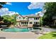 Lush backyard featuring a sparkling in-ground pool and ample seating at 121 Fairway Overlook, Woodstock, GA 30188