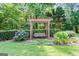 Beautiful backyard featuring a wooden swing and well-manicured landscaping at 121 Fairway Overlook, Woodstock, GA 30188