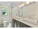 This bathroom offers double sinks and a glass-enclosed shower at 121 Fairway Overlook, Woodstock, GA 30188