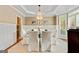 Dining room boasts wainscoting, chandelier, and neutral decor at 121 Fairway Overlook, Woodstock, GA 30188