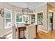 Bright dining room with hardwood floors, large windows, chandelier, and views of the backyard at 121 Fairway Overlook, Woodstock, GA 30188