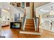 Grand foyer with hardwood floors, staircase, and chandelier at 121 Fairway Overlook, Woodstock, GA 30188