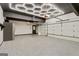 Well-lit garage featuring epoxy flooring and an automatic door opener at 121 Fairway Overlook, Woodstock, GA 30188